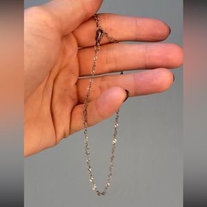 New. 18k filled rhodium twist, anklet, length 8 inch with a 2 inch extender.